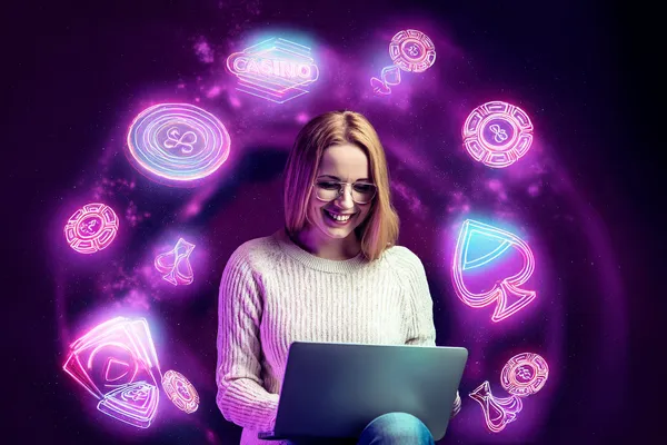 A woman smiling by bright slot machines showing lucky symbols, showcasing the exciting slot offerings at TKPK.